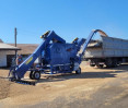 Self-propelled grain cleaning machine OBC-70M4L cleans and loads wheat into a truck Self-propelled grain cleaning machine OBC-70M4L cleans and loads wheat into a truck, photo